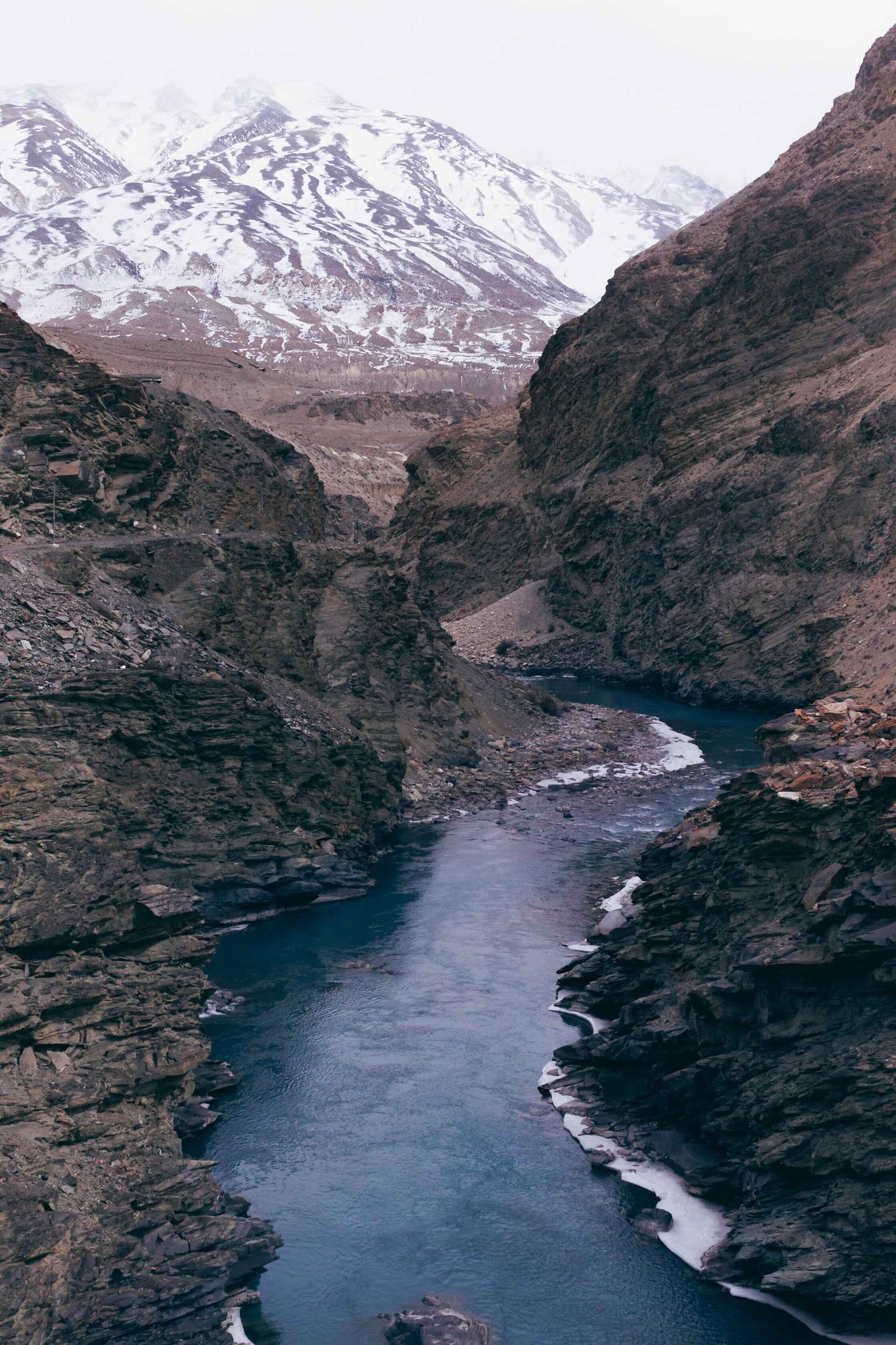 River winding through a gorge below snow-covered peaks